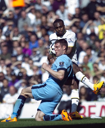 Danny Rose, tries to score past James Milner.