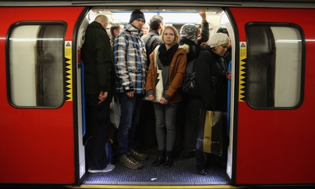 Commuters crowd on to a tube at Oxford Street station.