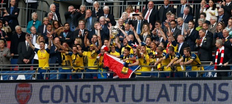 Arsenal celebrate with the trophy.