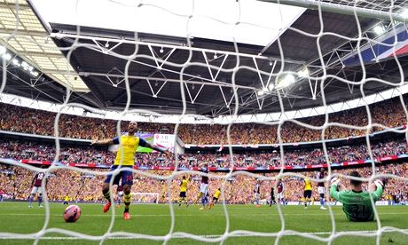 Arsenal's Theo Walcott celebrates team-mate Alexis Sánchez's long-distance goal against Aston Villa