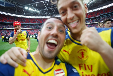 A selfie taken by Santi Cazorla of him and Mesut Ozil with Olivier Giroud watching on.