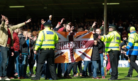 Motherwell fans invade the pitch.