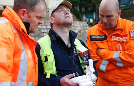 Members of the British NGO Serve On guide a drone above Chautara, Nepal. 