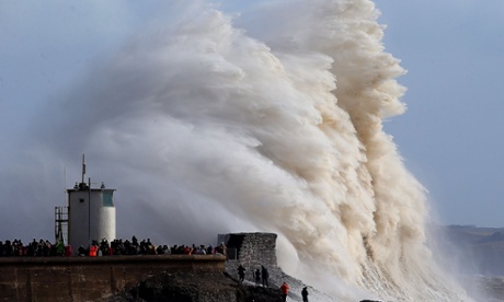 Waves crash into the lighthouse at Porthcawl, south Wales
