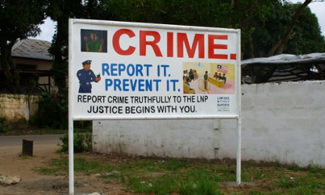 Sign urging people to report crimes to the Liberia National Police