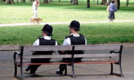 Two police officers enjoy the sunshine, safe in the knowledge that crime is falling as they relax.
