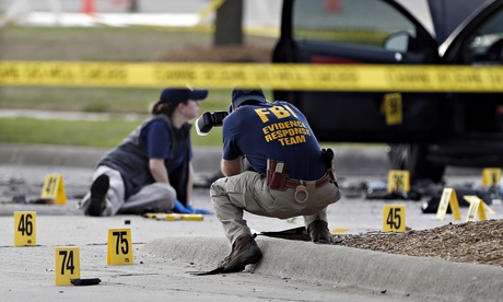 FBI investigators at the sene where two men were shot dead outside a centre in a suburb of Dallas, T