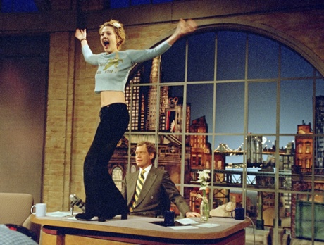 Drew Barrymore turns to the audience after flashing host David Letterman during the April 12, 1995 taping of the Late Show with David Letterman in New York City. This show was taped on Dave's Birthday.