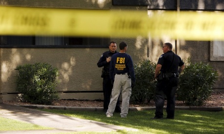 Law enforcement officers at the Autumn Ridge apartment complex searched by investigators in Phoenix, Arizona, after two gunmen were shot dead at an exhibit of caricatures of the Prophet Mohammad.