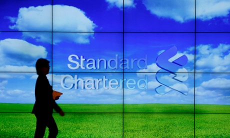A staff member walks inside a priority banking service area of a Standard Chartered bank in Hong Kong in this August 1, 2012 file photo.