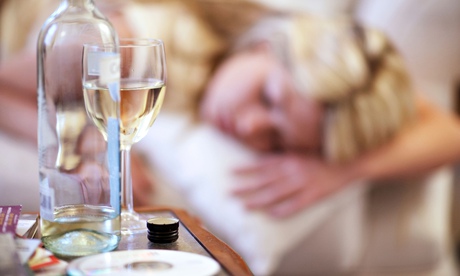 Woman alseep on sofa with wine
