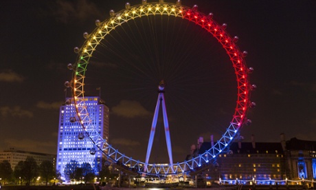 London Eye lit up with colours of political parties.
