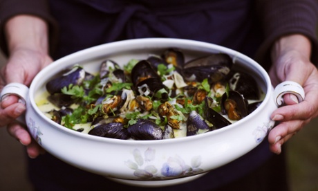 Woman holding pot of mussels, close-up