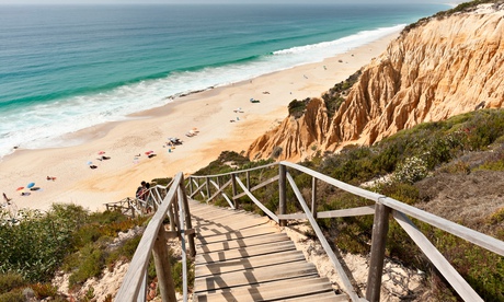 Wooden staircase in the sandstone cliffs at Comporta, Portugal