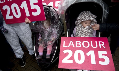 babies in push chairs with big red placards saying Labour 2015