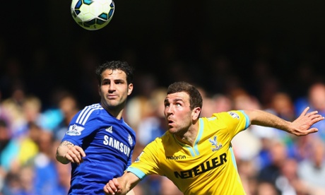 James McArthur of Crystal Palace takes on Cesc Fabregas of Chelsea.