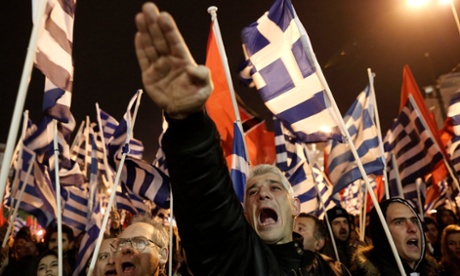 A supporter of Greece’s extreme right party Golden Dawn gives a Nazi salute during a rally in Athens.