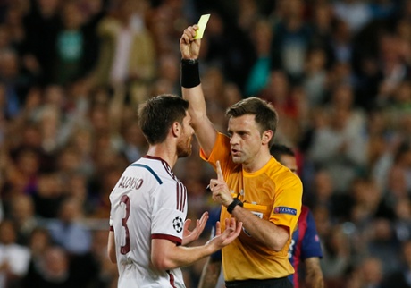 Alonso is shown a yellow card by referee Nicola Rizzoli.