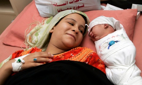 Mum's the word … a newborn baby lies beside her mother in a hospital in the Iraqi capital Baghdad.