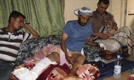 People visit a man injured during a recent clashes between tribal fighters who support the Saudi-led campaign and Shia rebels, at his home in Taiz, Yemen.