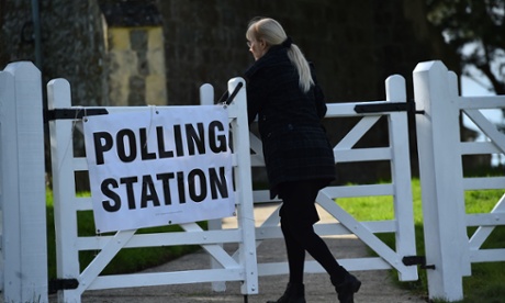 A woman arrives to cast her vote at a polling station at a church in Standford, southern England.