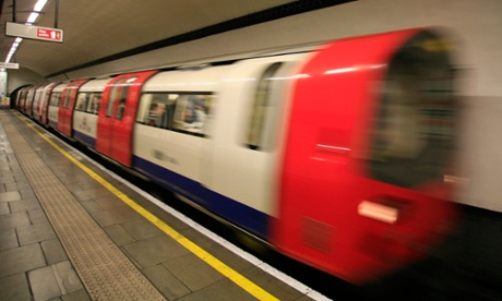 A train arrives at a London Underground station.