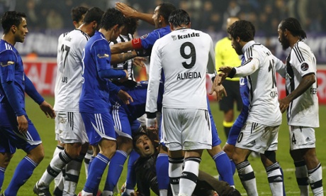 Players react after a supporter ran on to the pitch to kick Besiktas' Manuel Fernandes during the game against Kasimpasaspor.