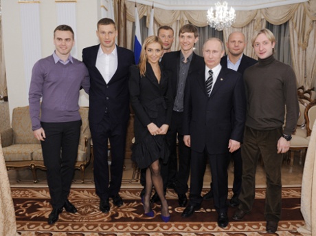 Roman Pavlyuchenko, standing just behind Vladimir Putin during a Moscow meeting in March 2012.