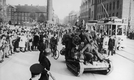 German troops on a midget tank retreat through the Town Hall Square in Copenhagen after VE Day.