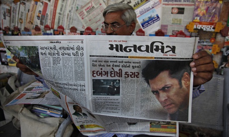 An Indian man reads about the five-year sentence given to Salman Khan, one of India's biggest stars