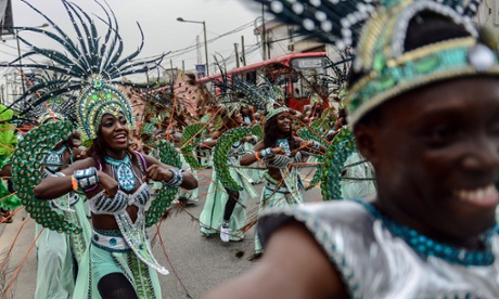 Traditional dance groups march in the carnival in Lagos