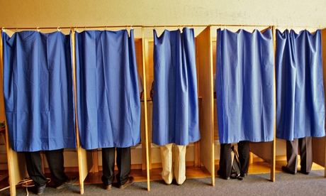 VOTERS VOTE IN A VOTING BOOTH AT A POLLING STATION DURING LOCAL ELECTIONS