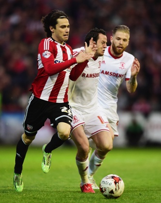 Jota and Lee Tomlin battle for the ball.