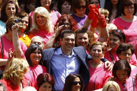 Gloves off … Alexis Tsipras last week with cleaners celebrating victory in their two-year fight to win back their jobs at Athens's finance ministry.