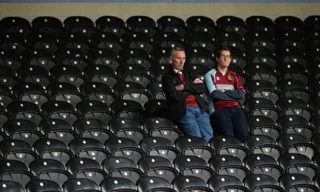 Burnley fans sit in their seats after being relegated from the Premier League