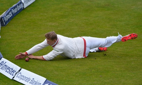 England fielder Joe Root fails in his attempt to stop a ball going to the boundary.