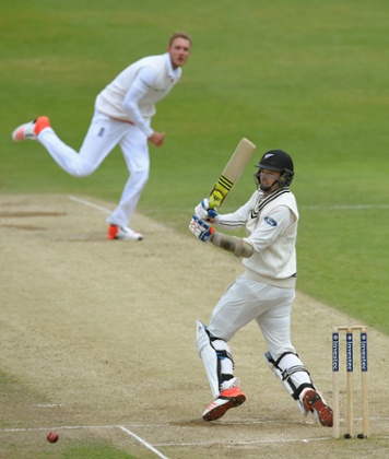 Stuart Broad looks on as Tim Southee pulls a ball to the boundary for four runs.