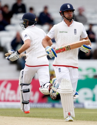 Alastair Cook and Adam Lyth (behind) add to England's total.