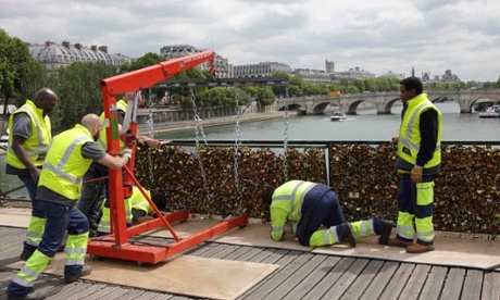 Workmen remove iron grills covered with 