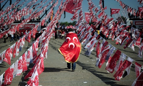 A man walks with a flag of the Nationalist Movement party (MHP) during a campaign rally in Istanbul.