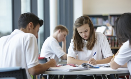 Group of teenagers working in school class