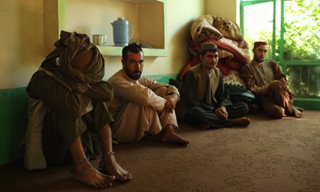 A patient in ankle shackles waits for treatment with others at the drug rehabilitation centre in Tarin Kot.