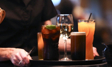 A waitress prepares to carry a tray of drinks to a customer inside The Yew Tree pub, operated by Chef and Brewer, a unit of Spirit Pub Co., in Great Horkesley, U.K., on Wednesday, Oct. 15, 2014. 