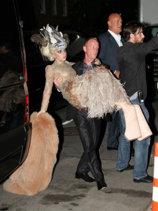 Lady Gaga being carried by her bodyguard.