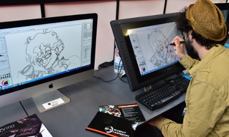 An artist draws a cartoon on a screen during the 
