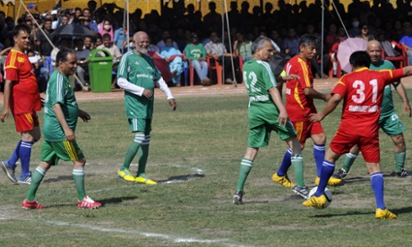 Nepal’s Prime Minister Sushil Koirala (3rd left) and Maoist UCPN Chairman Prachanda (2nd left) take part in a friendly football match between politicians and actors to collect funds for earthquake victims in Kathmandu on 6 June 2015.