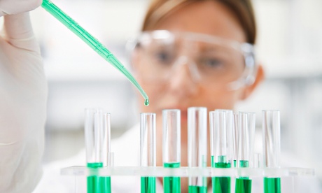Female scientist filling test tubes in a laboratory