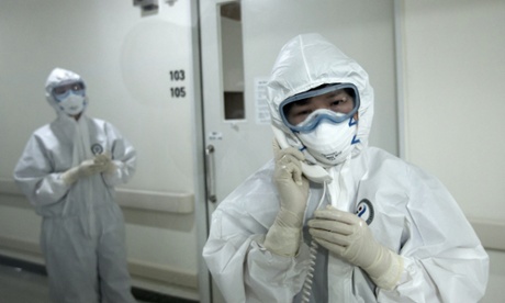 Health care workers wearing full-body protective gear inside an isolation ward at Seoul medical centre
