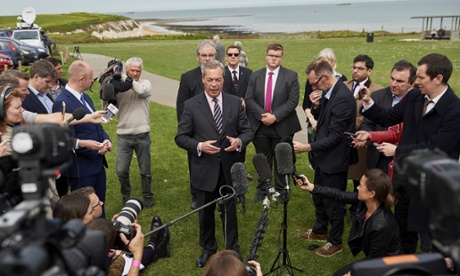 Nigel Farage faces the media after defeat.