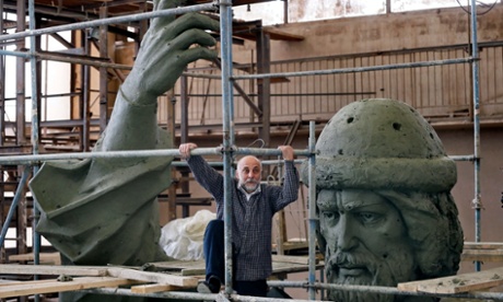 Russian artist Salavat Scherbakov poses beside his huge sculptor of Vladimir the Great in his Moscow workshop.